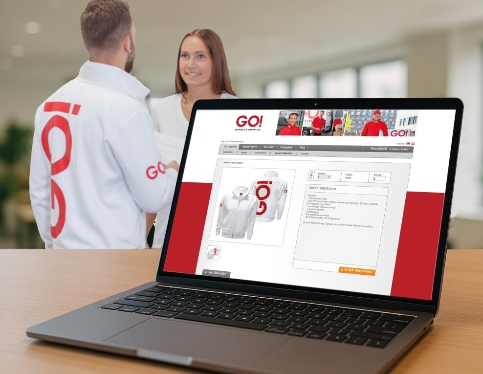 COW: Der Webshop für Ihre Kollektion Laptop mit geöffnetem COW Webshop und GO! Mitarbeitern im Hintergrund